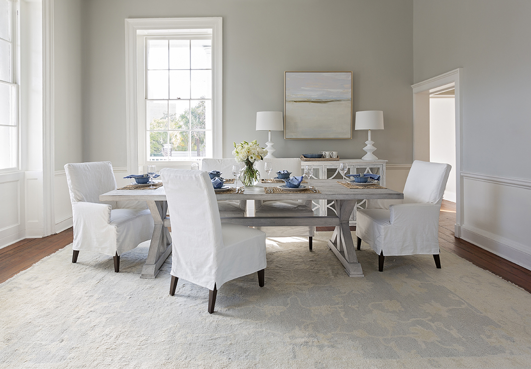 minimal white dining room with art print hanging on dining room wall
