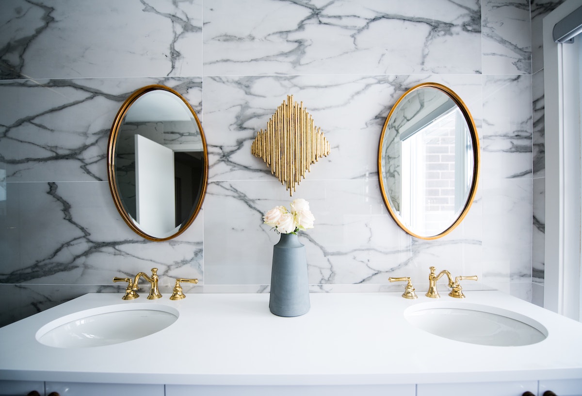 Bathroom Double Sink with Gold Mirrors and Decor