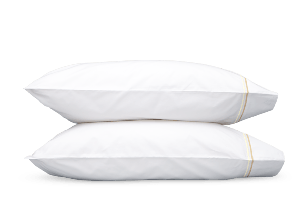 The Essex Pair of Pillowcases, in white accented with two satin lines, stacked on top of each other. Find it at GDC's Mt. Pleasant home decor stores