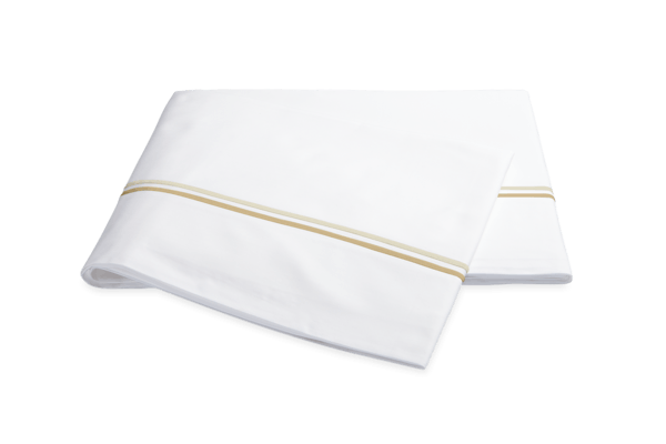 The Essex Flat Sheet, accented with a pair of crisp lines of satin stitch embroidery in colors from subtle to cheerful. Available at Charleston home decor stores