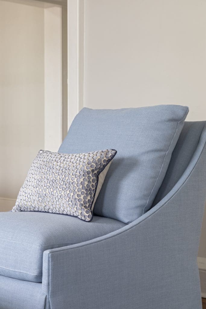A comfy chair with soft accent pillow by Charleston furniture store GDC home 