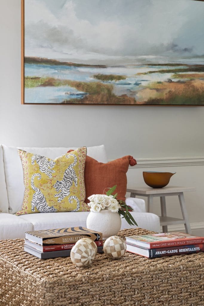 Burnt Orange accent pillow mingles the with autumnal colors of the living room decor on a couch by Charleston furniture store GDC