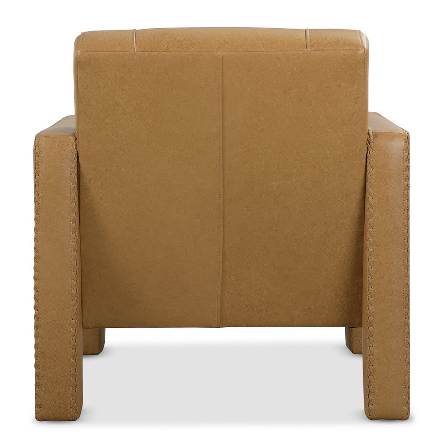 back view of a tan leather upholstered armchair with sturdy arms and detailed stitching