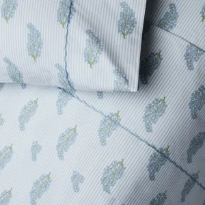 detail of light blue striped bedding with floral sprig pattern, sheets and pillowcases, blue hand stitching detail