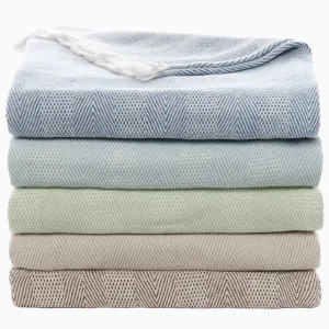 stack of five herringbone throws with fringe