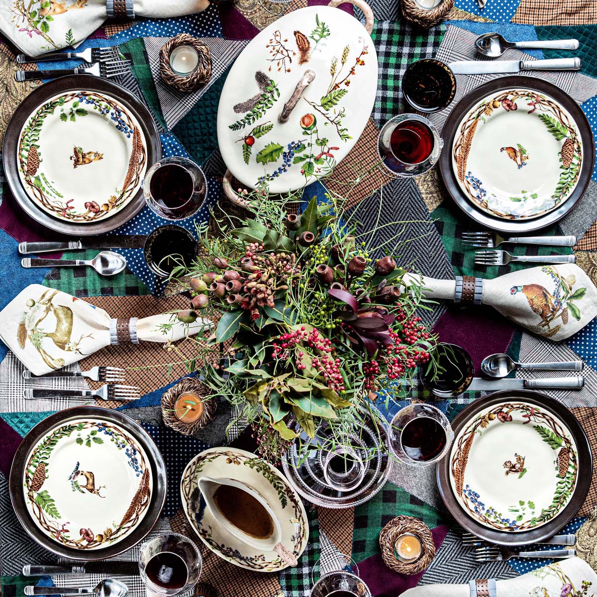 overhead view of a table set with woodland inspired dinnerware and serving pieces