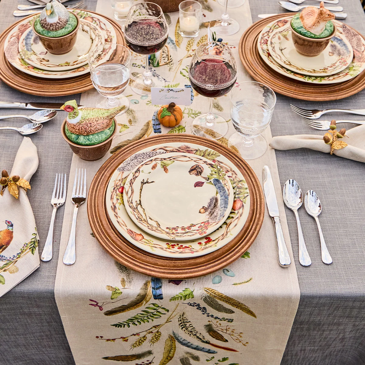 table set with woodland inspired dinnerware and serving pieces