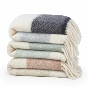 stack of three striped faux mohair throws with fringe