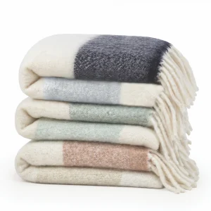 stack of three striped faux mohair throws with fringe