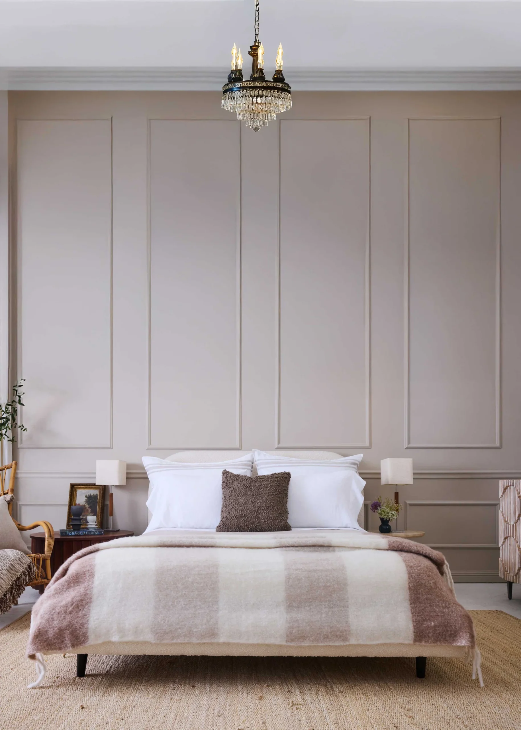 Neutral room with natural and ivory striped faux mohair throw at the end of a bed