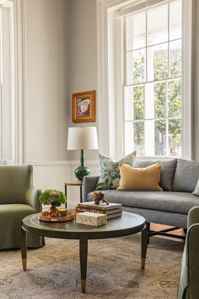 a living room styled with Charleston furniture and home decor in a neutral color palette with some earthy pops of color