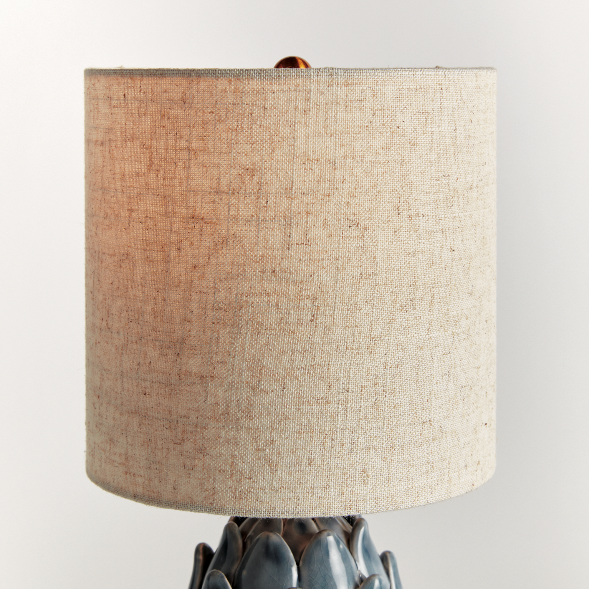 detail of natural linen shade on a blue artichoke inspired lamp