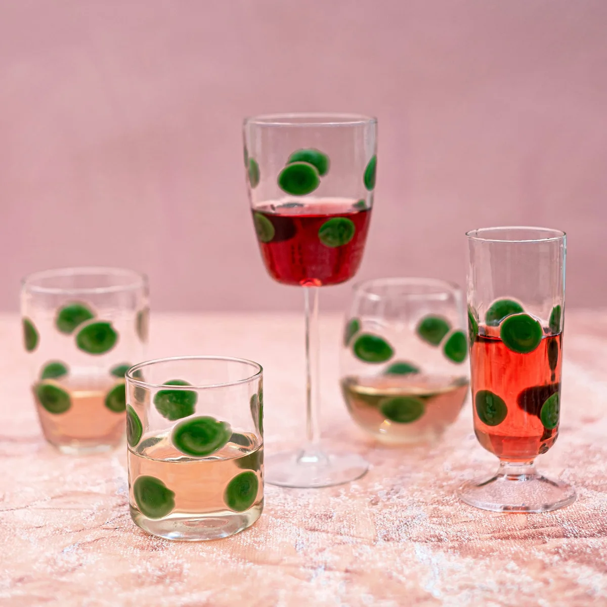 group of glassware with green dots