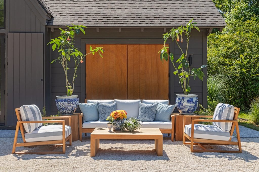a resort-style patio furniture setup using deep seating outdoor furniture, including an outdoor sofa, two outdoor armchairs, and an outdoor coffee table in a coastal design style