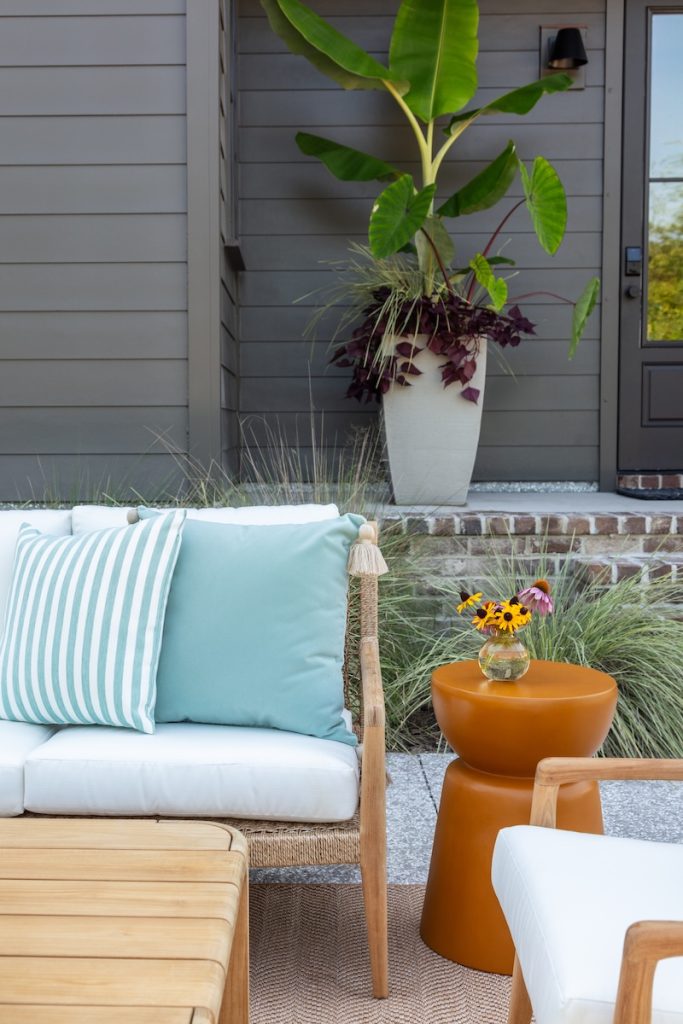 close-up view of luxury outdoor patio furniture arrangement in a coastal design style, using deep seated patio furniture