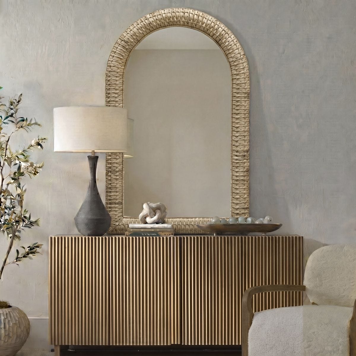 lifestyle image of arched mirror with console, lamp, accessories, twisted natural seagrass, sold by GDC Home in Charleston, SC