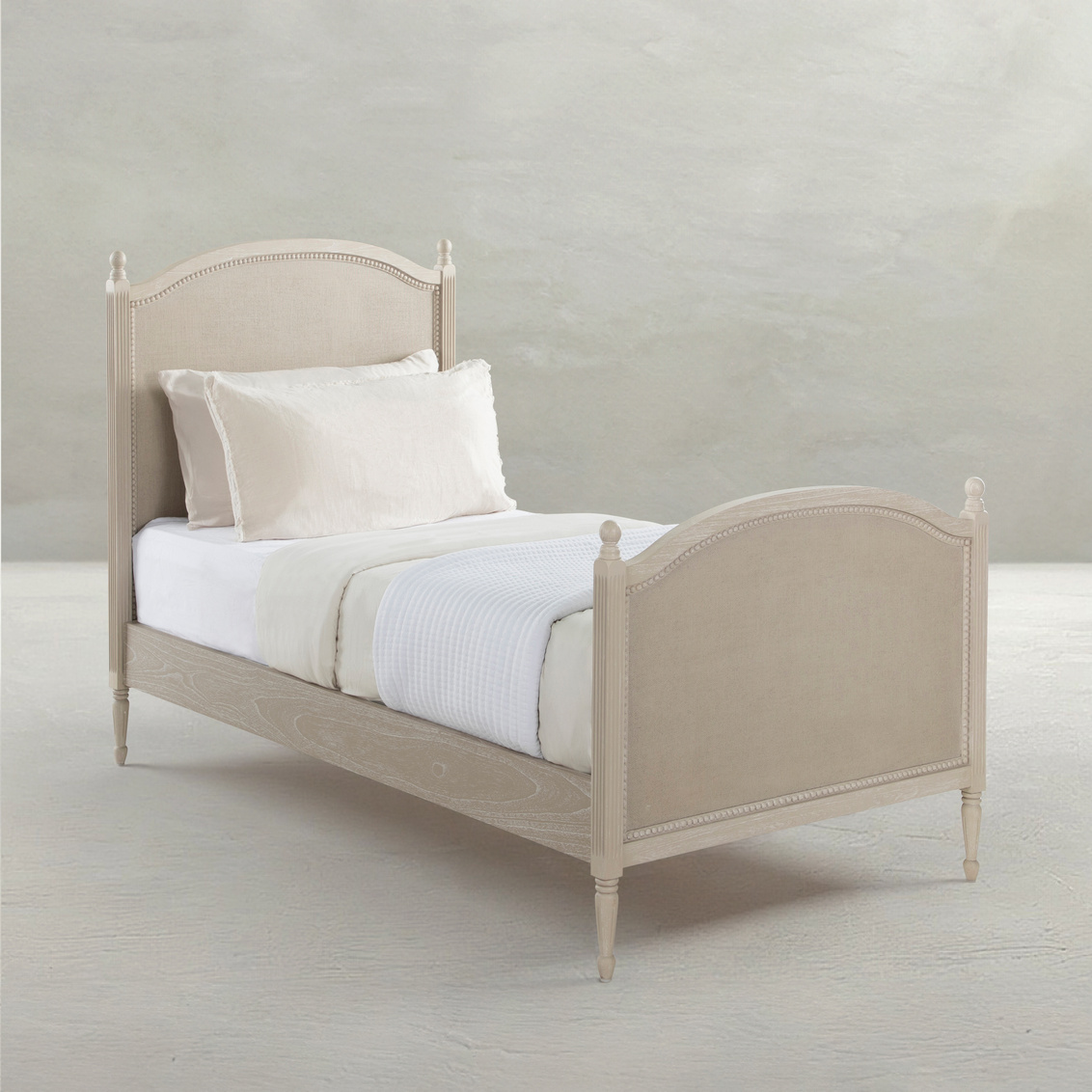 Twin bed in cerused white finish with painted burlap panels. Sold by GDC Home in Charleston, SC