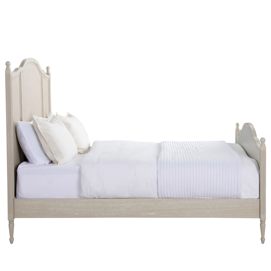 Side view of bed in cerused white finish with painted burlap panels. Sold by GDC Home in Charleston, SC