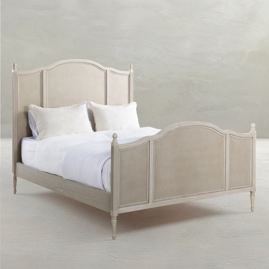 Queen bed in cerused white finish with painted burlap panels. Sold by GDC Home in Charleston, SC