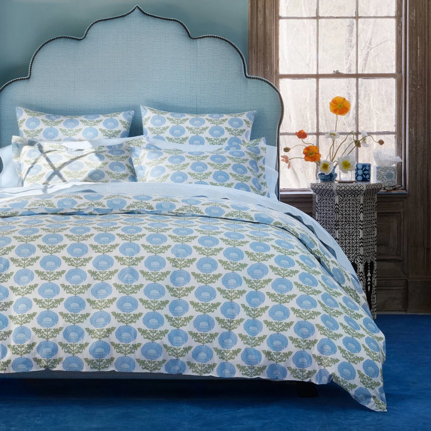 lifestyle image of duvet and shams with green and blue floral block print