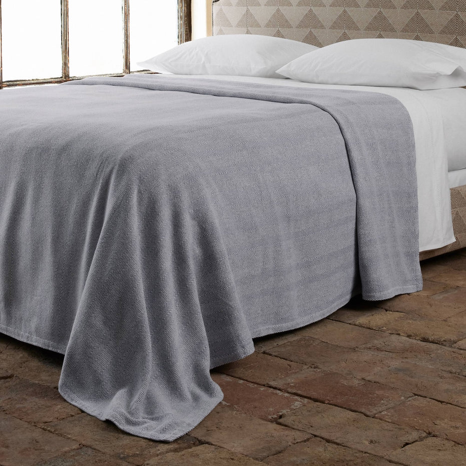lifestyle image of herringbone cotton blanket in indigo