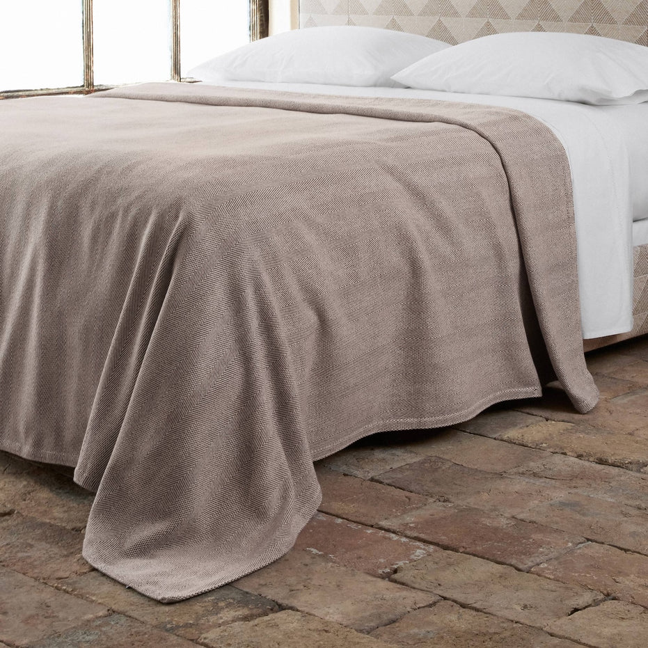 lifestyle image of herringbone cotton blanket in brown