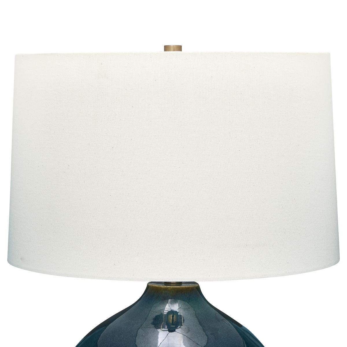 detail of white shade on round deep blue table lamp