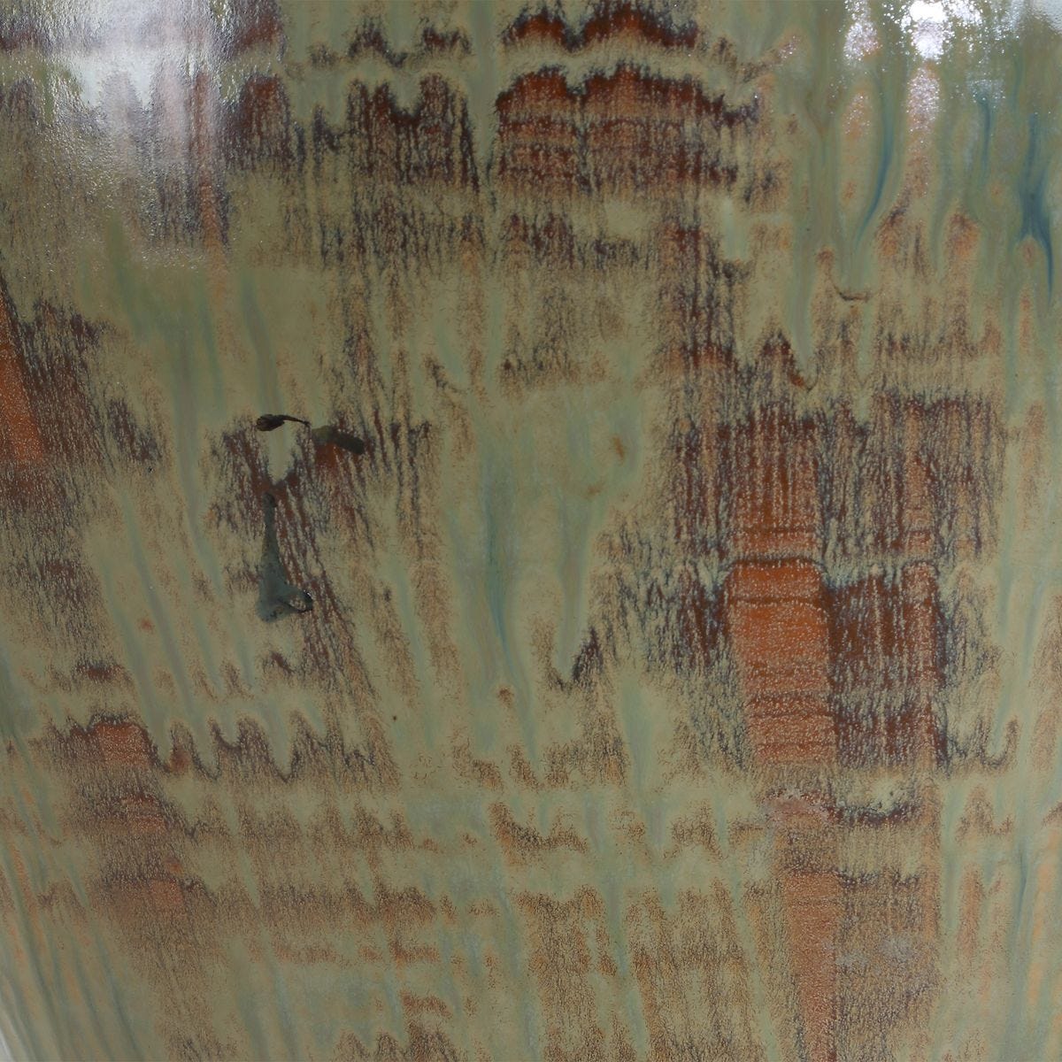 detail of table lamp with urn base finished in shades of green, blue-green, and earthy browns