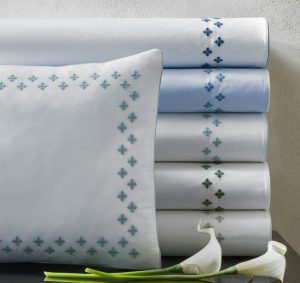 stack of duvet covers and one sham with embroidered Moroccan tilework design