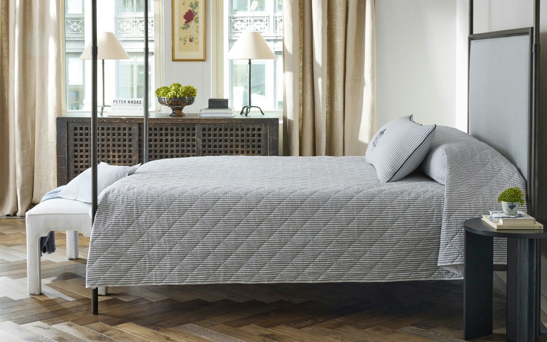 bed made up in dark navy seersucker quilt