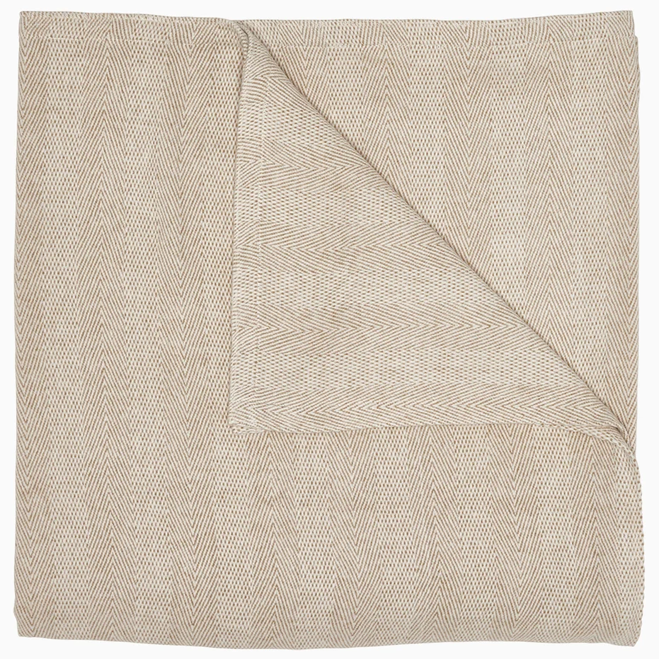 folded herringbone cotton blanket in light brown
