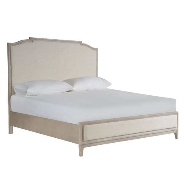 Quietly luxurious upholstered bed in a soft off-white color