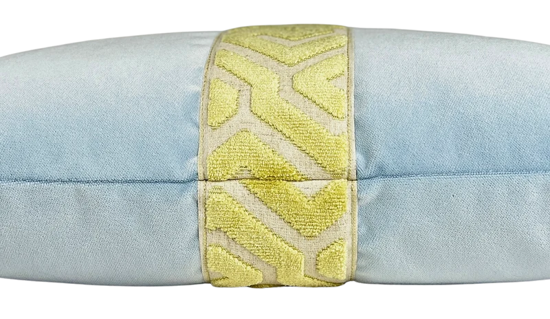 side view of a light blue velvet lumbar pillow with a celery green geometric embroidered center band