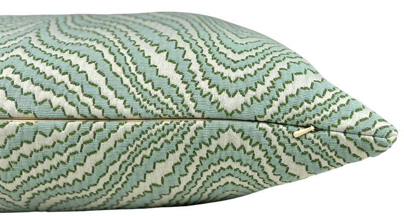 detail of woven chevron ripple pattern decorative pillow in shades of spa and spring green