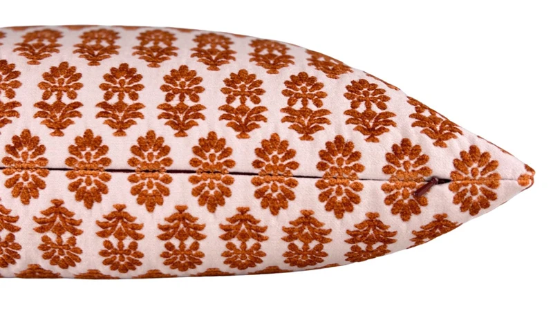 detail of textured block print lumbar pillow in pink and orange