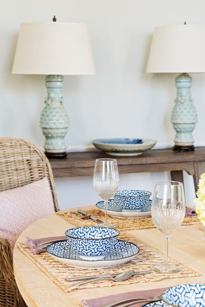 Two table lamps on a side table with sculptural bases and neutral lampshades from GDC Home's Charleston lighting stores