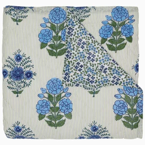 light green striped quilt with blue block print flowers