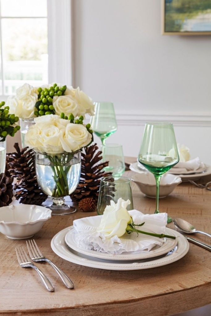 A coastal dining table featuring a floral table centerpiece display, styled with GDC's home decor Charleston SC