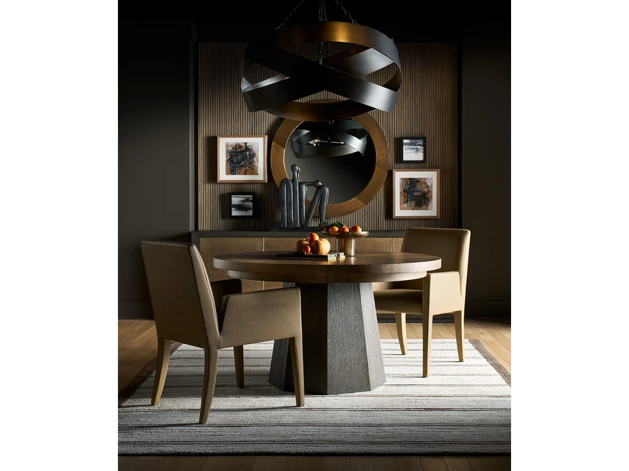 lifestyle image of the Brume dining arm chair with a round dining table, light brown leather, dark and moody interiors
