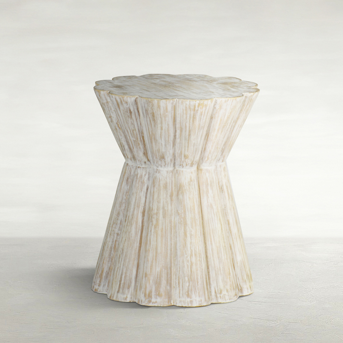 side table with scalloped edges and light washed wood finish, sold by GDC Home in Charleston