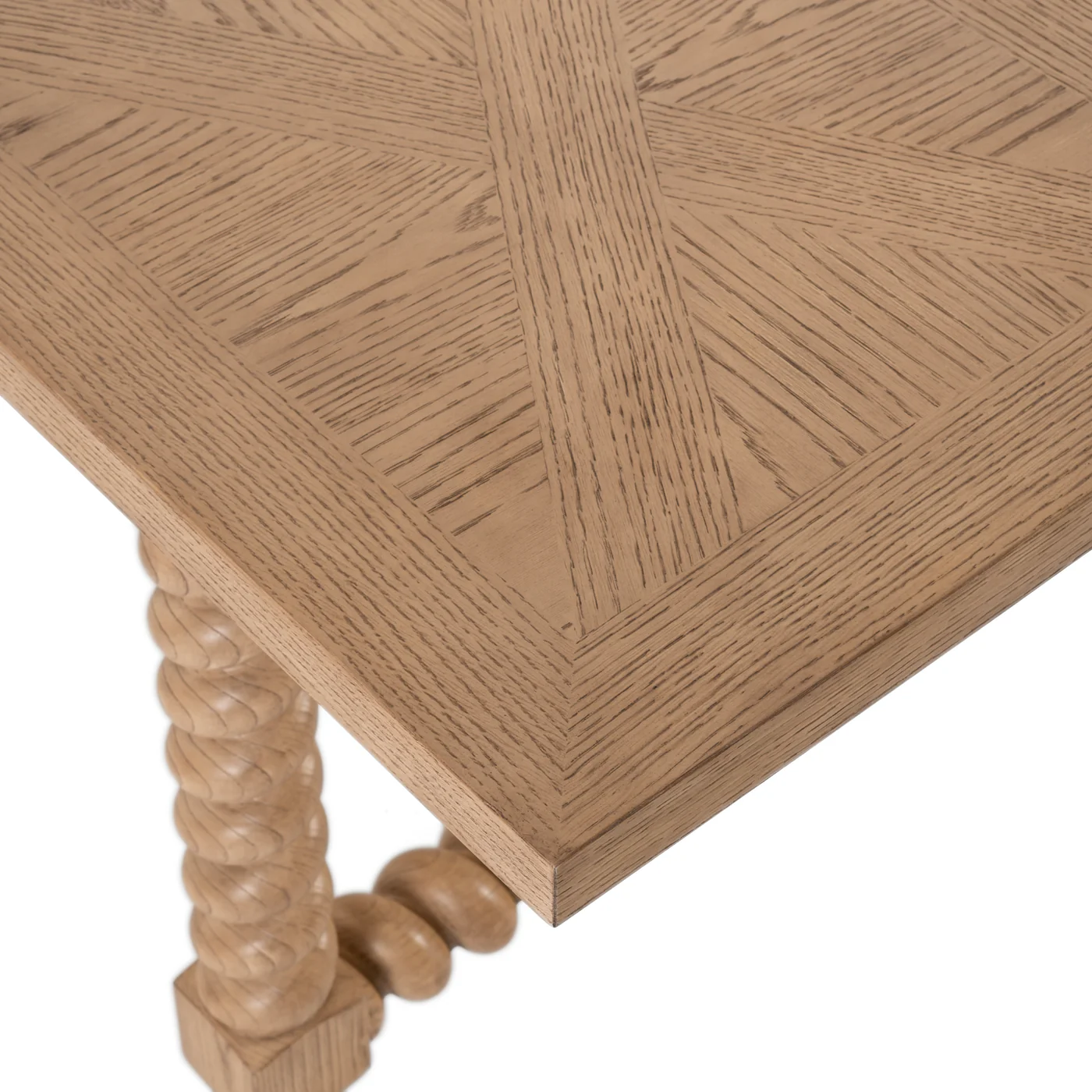 detaill of 84" dining table with turned legs in light blonde hue