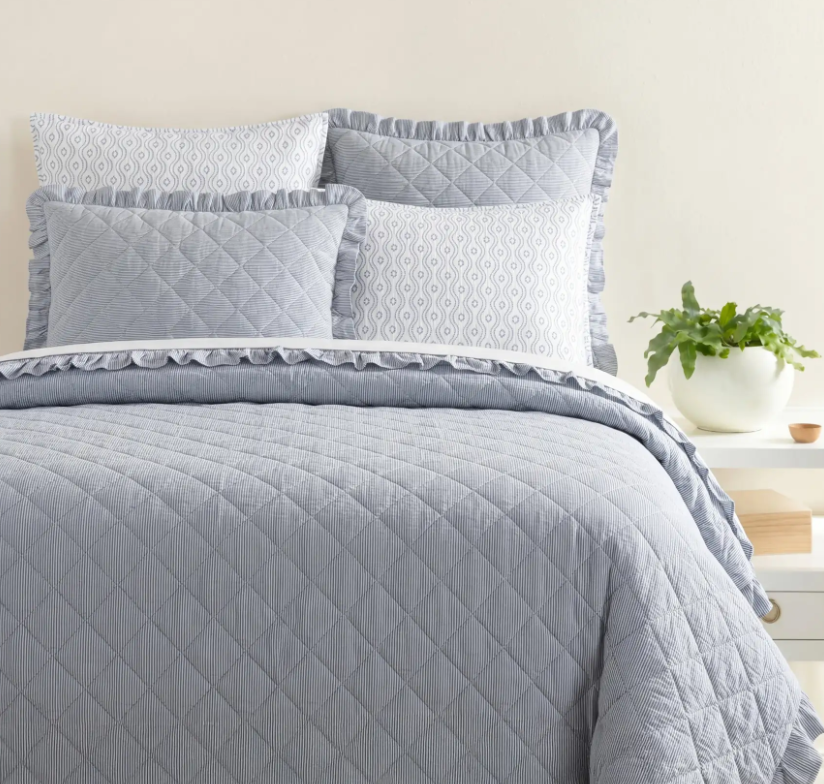 lifestyle image of ruffled french blue quilt, ruffled french blue quilted shams, block print shams, coastal