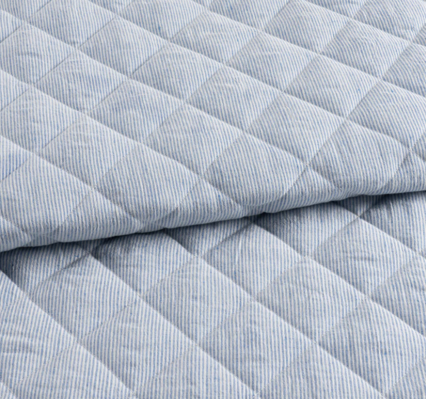 detail of quilted french blue linen bedding