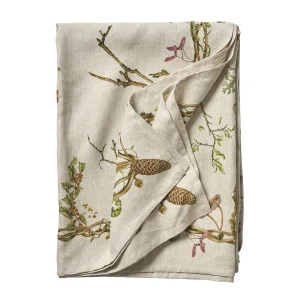folded linen tablecloth with whimsical motif of flora, fauna, and found woodland treasures