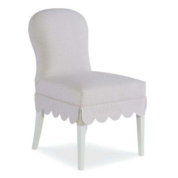 A side chair with a slim profile and scalloped bottom edge