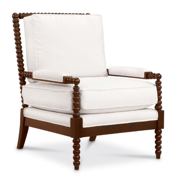 A classical accent chair with a dark wooden frame and light cushions