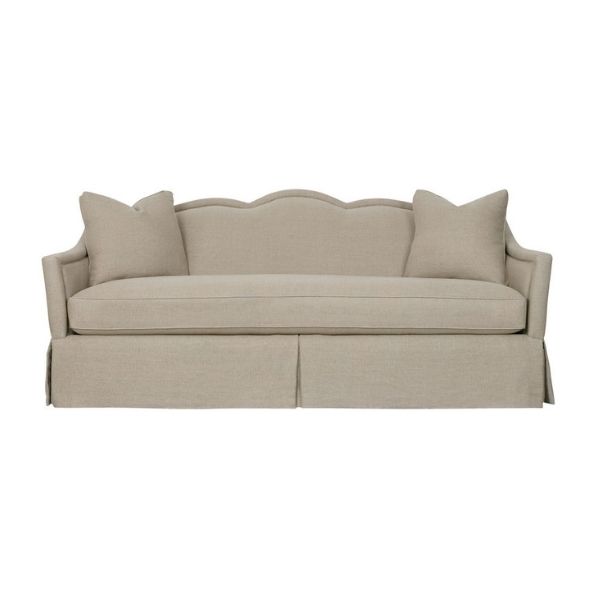 A bench seat sofa with a scalloped back and sophisticated sofa silhouette, available at GDC Home's Charleston furnitures stores