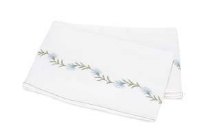 folded white flat sheet with light blue and green floral vine embroidery
