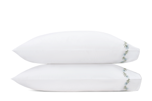 pair of white pillowcases with light blue and green floral vine embroidery