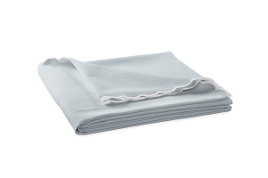 folded diamond patterned icy blue-grey coverlet with scalloped edges